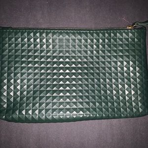 A green diamond shaped pattern clutch